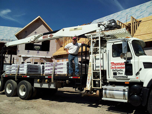 Man standing on a white delivery truck